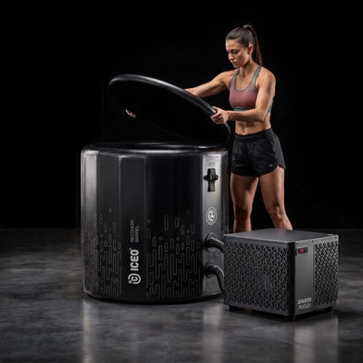 Vrouw opent het deksel van de ICEO Recovery Barrel Pro met de koeler ernaast